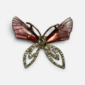 Jakris elegant butterfly brooch featuring pink translucent wings and gold-tone crystal embellished lower wings