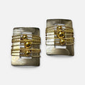 Jakris rectangular earrings featuring a brushed silver frame with layered gold-tone beaded chains and central spheres