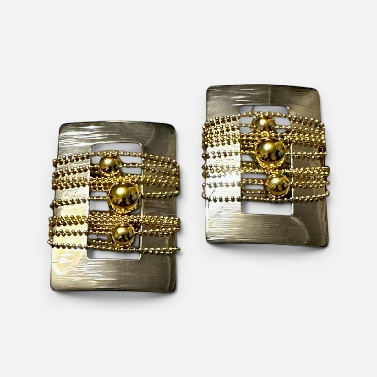 Jakris rectangular earrings featuring a brushed silver frame with layered gold-tone beaded chains and central spheres