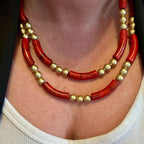 Jakris double-strand necklace featuring bold red tube beads and gold-plated spherical beads in a vintage style.