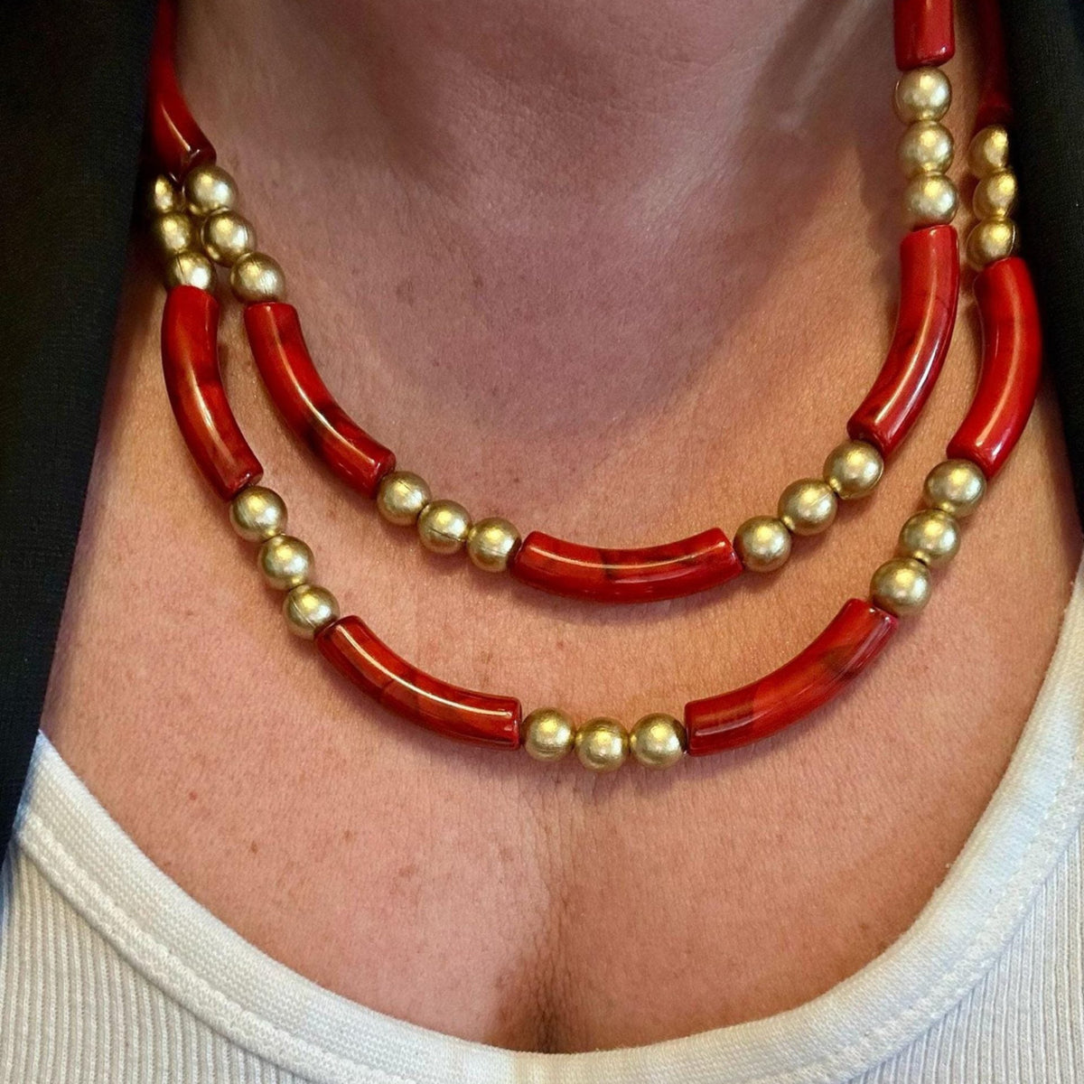 Jakris double-strand necklace featuring bold red tube beads and gold-plated spherical beads in a vintage style.