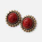 Jakris red sun earrings featuring a polished red cabochon center surrounded by a gold-toned sunburst petal frame.