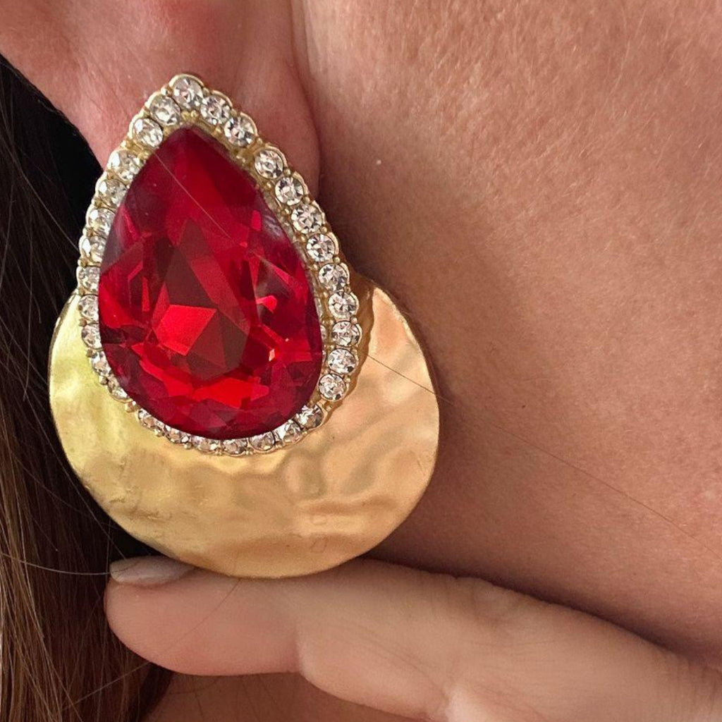 Jakris red teardrop evening earring with a large crystal, rhinestone border, and hammered gold circular base