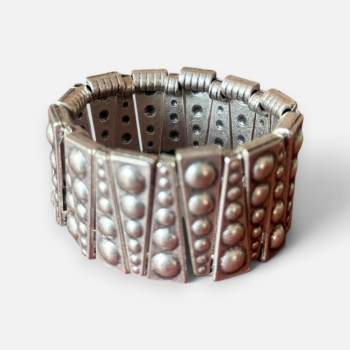 Jakris silver-toned elastic bracelet featuring geometric metal plates with embossed stud details