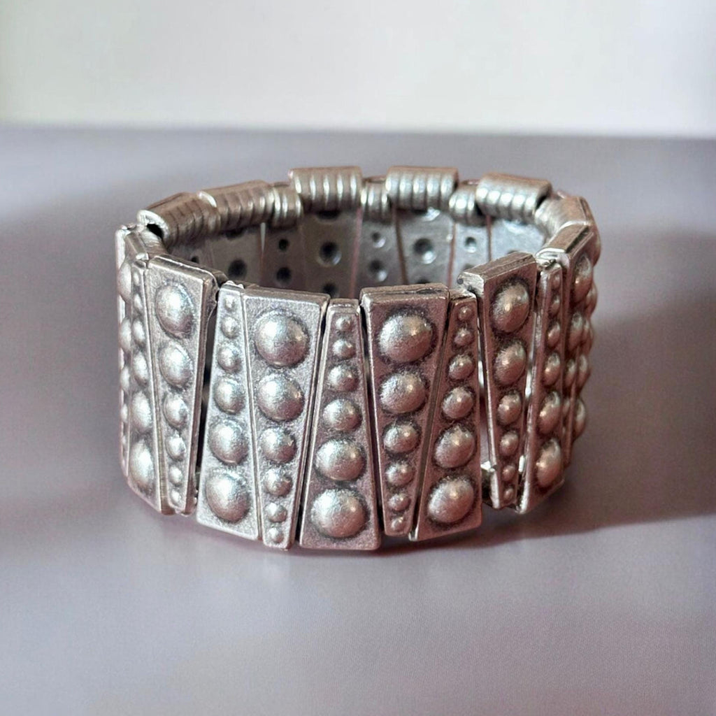 Jakris silver-toned elastic cuff bracelet featuring geometric metal panels with raised stud detailing