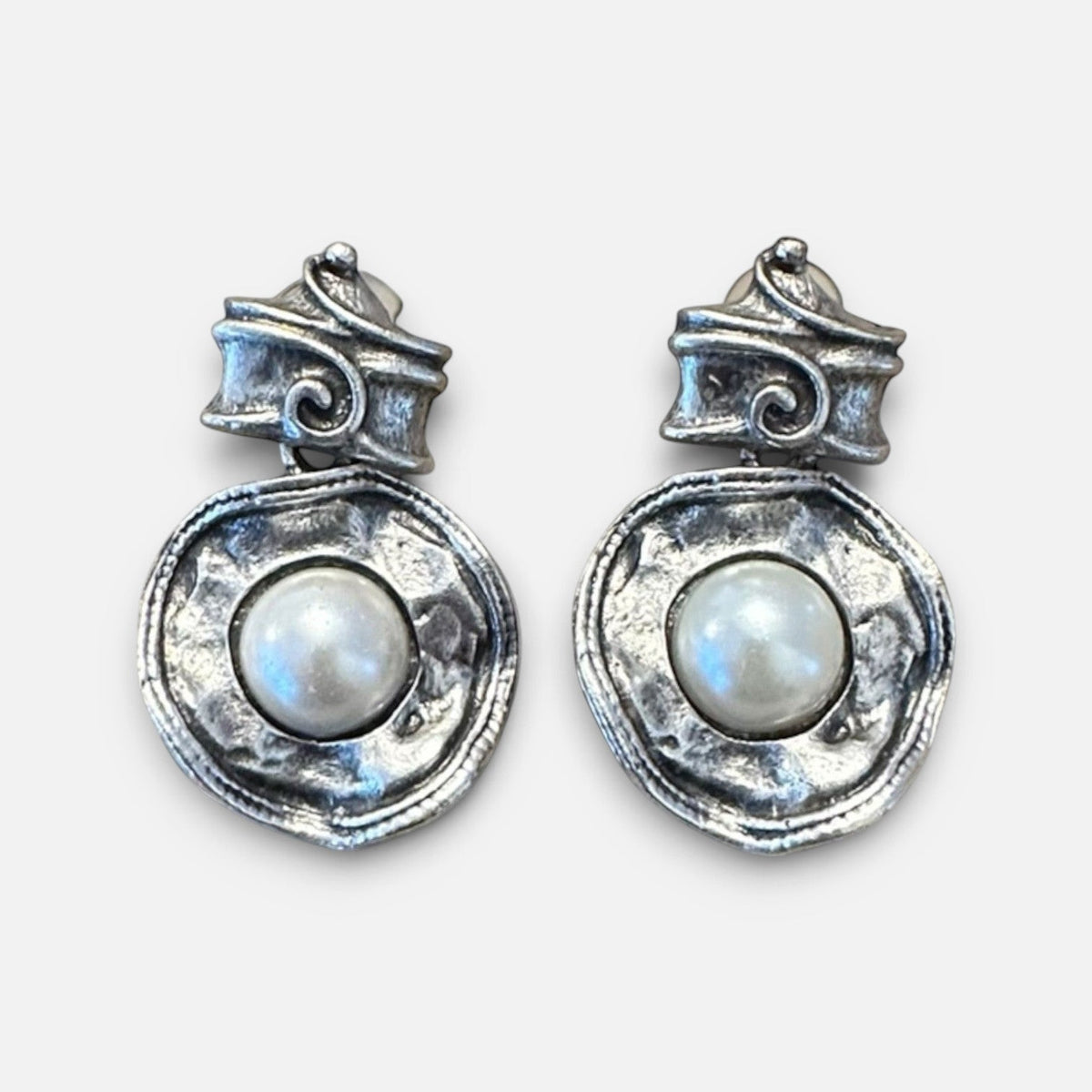 Jakris silver-tone earrings featuring a hammered metal design with a central white pearl and scroll-top detail