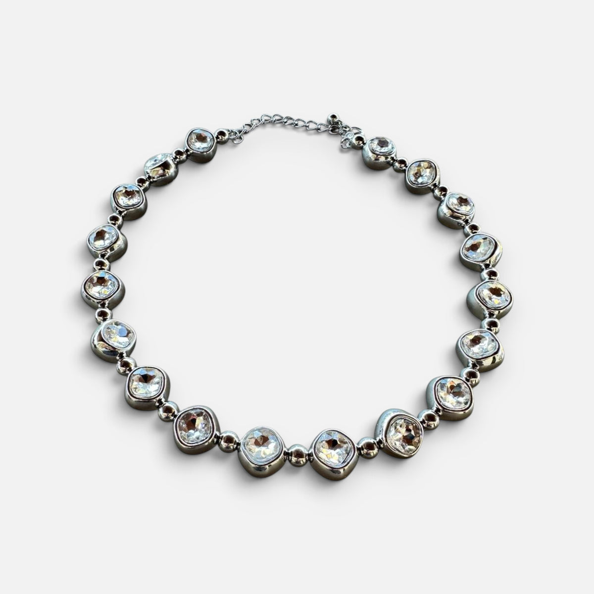 Jakris silver-tone choker necklace featuring large clear faceted stones in a circular link design