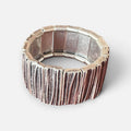 Jakris silver-toned elastic wide bracelet with a textured, rustic finish on a neutral background.