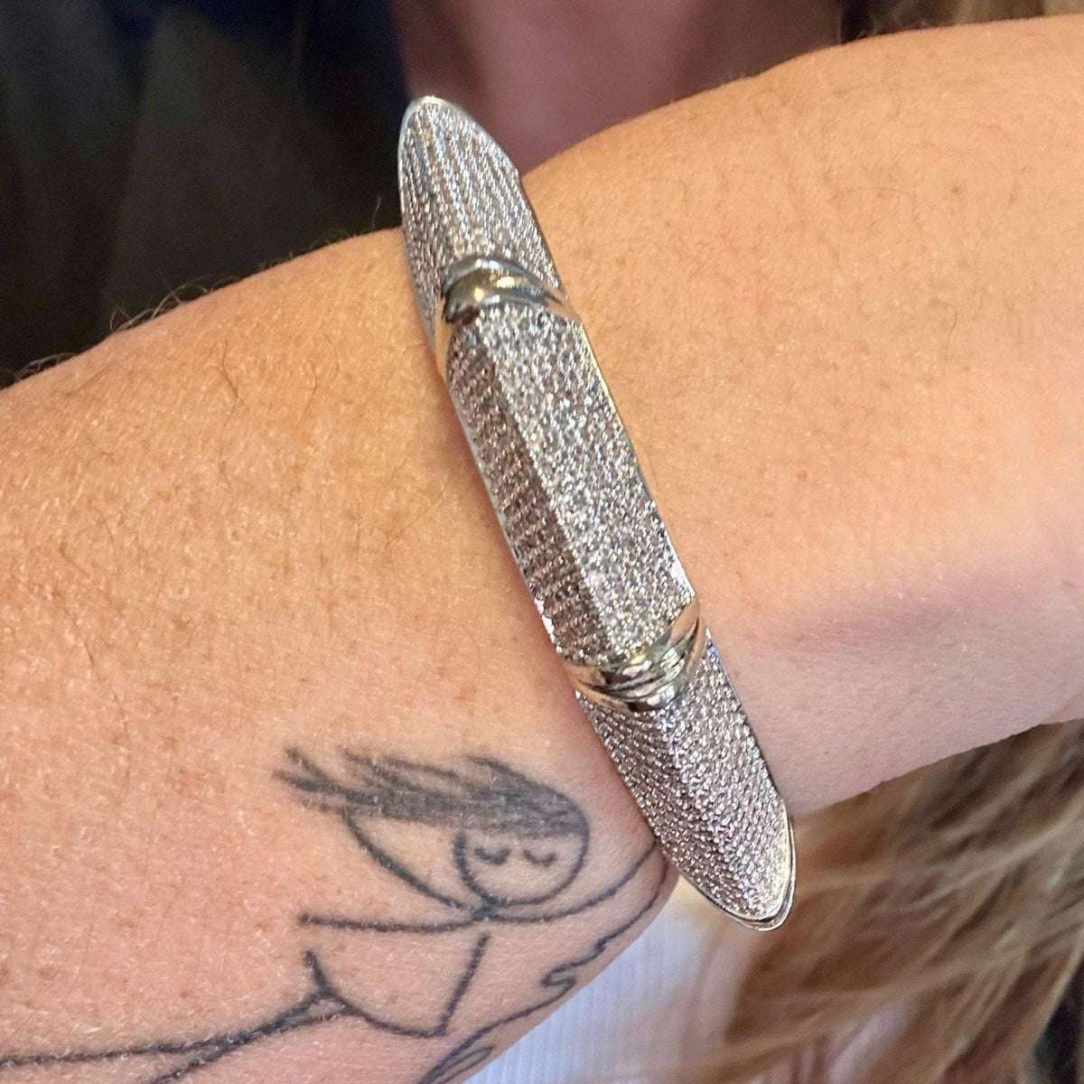 Jakris silver cuff bracelet encrusted with sparkling zircon stones worn on a wrist