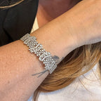 Jakris silver tone evening bracelet featuring intricate crystal zircon embellishments worn on a woman's wrist