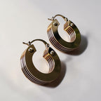 Jakris small gold hoop earrings featuring a layered 5-tier thick design with a polished metallic finish.