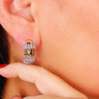 Jakris small gold hoop earrings with baguette and round cut sparkling stones worn on a woman's earlobe