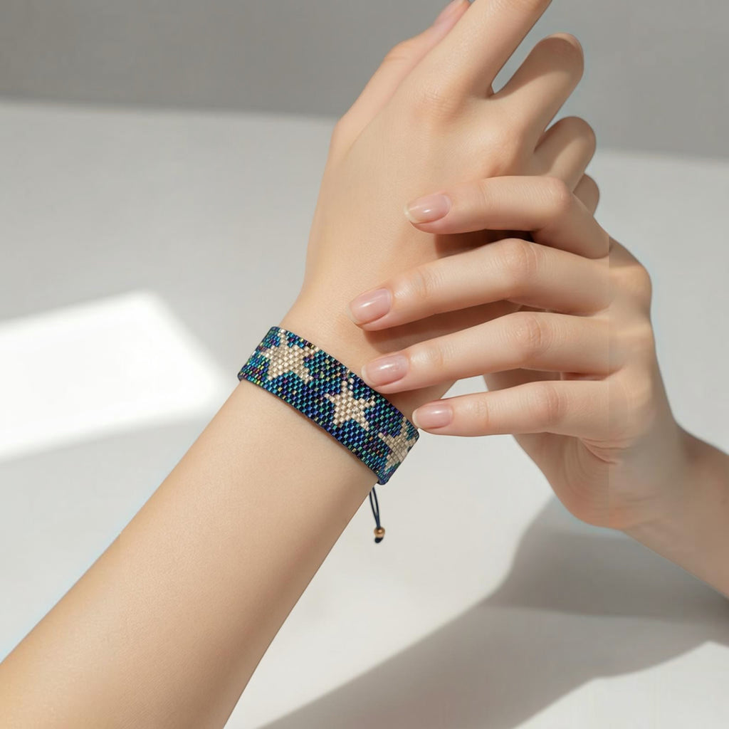 Jakris woven beaded bracelet featuring a blue and gold star pattern on a woman's wrist