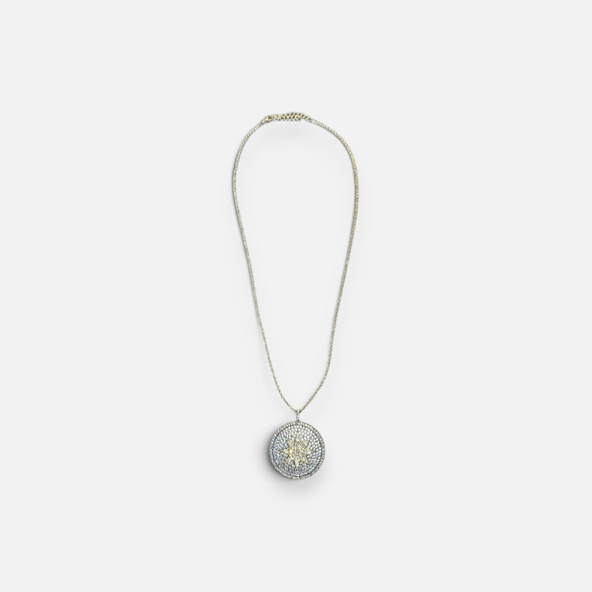 Jakris round pendant necklace featuring a sparkling star motif set with clear and yellow zircon stones on a fine chain