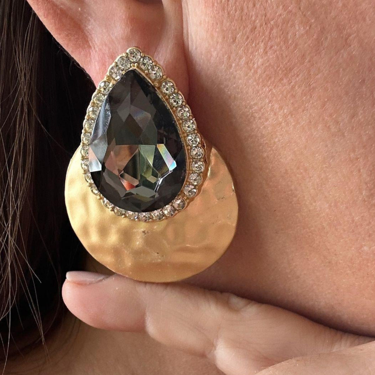 Jakris teardrop evening earring featuring a large grey crystal, rhinestone halo, and gold textured metal disc