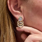 Jakris elegant teardrop earrings featuring sparkling stones and gold-tone interlocking rings worn on an earlobe