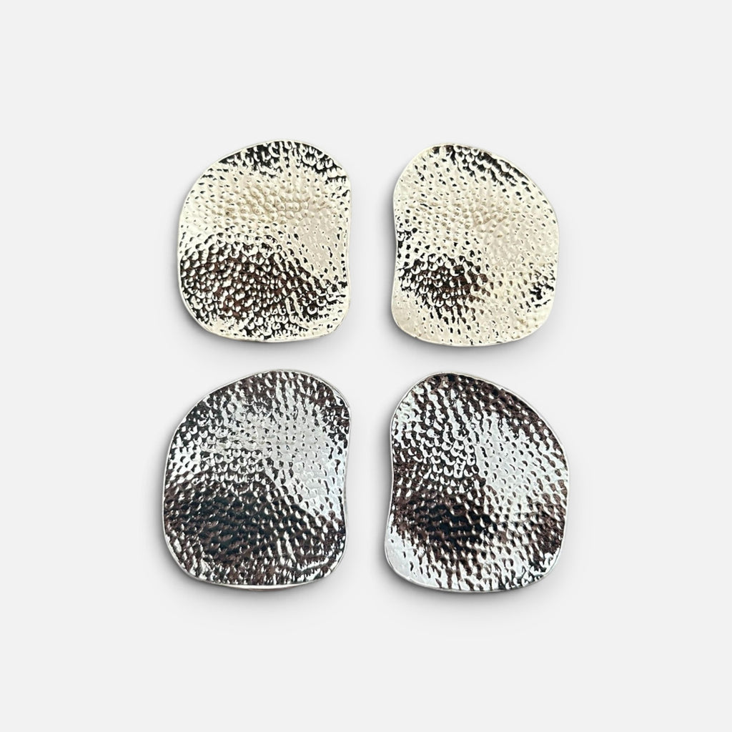 Jakris metallic asymmetric earrings with a textured hammered finish in silver tone