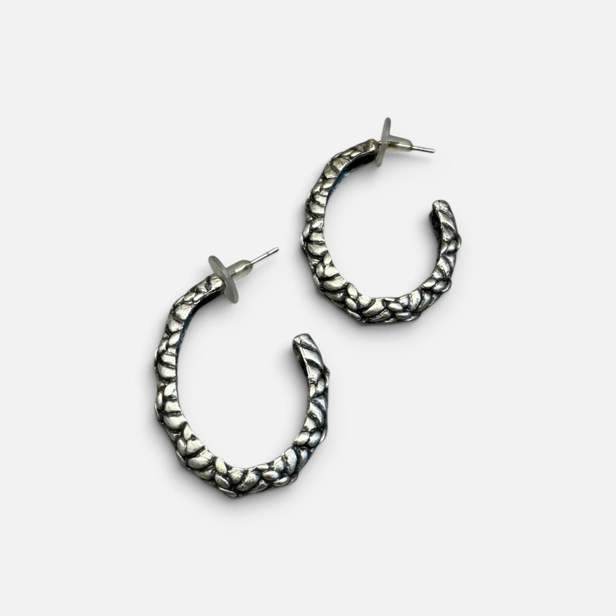 Jakris silver-plated hoop earrings with a textured surface and post back closure for a modern, stylish look.