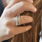 Jakris three-band ring featuring mixed gold and silver tones with sparkling zircon stones worn on a woman's finger.