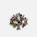 Jakris vintage tree of life brooch featuring colorful crystal stones set in a silver-tone metal tree design