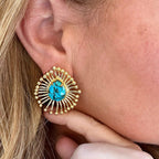 Jakris bohemian sun-shaped stud earring featuring a vibrant turquoise stone set in vintage gold-plated metal.