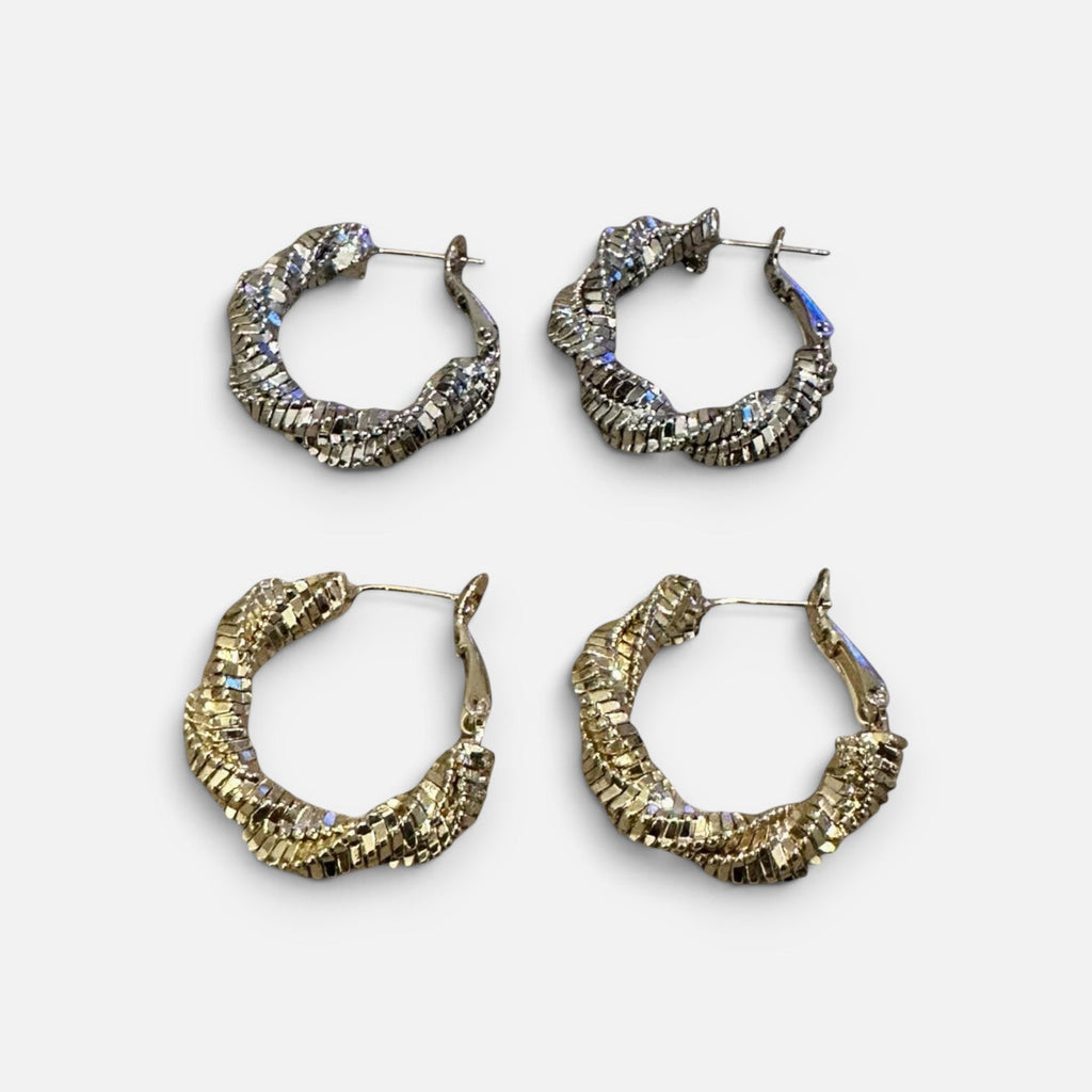 Jakris shiny twisted hoop earrings in gold and silver tones, featuring a textured metallic finish for party wear.