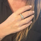 Jakris twisted gold ring with sparkling zircon stones worn on a woman's finger