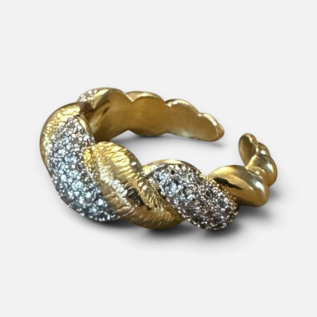 Jakris gold-tone twisted ring featuring sparkling zircon stones in a textured, elegant design.