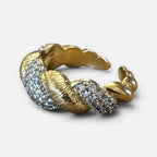 Jakris gold-tone twisted ring featuring sparkling zircon stones in a textured, elegant design.