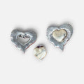 Jakris vintage style two-piece detachable silver heart earrings with textured radiating lines on a marble surface