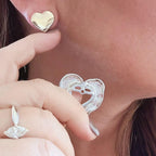 Jakris vintage style two-piece detachable silver heart earrings worn on a model's ear