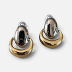 Jakris vintage two-tone shield dangle earrings featuring a polished silver oval and a gold crescent design.