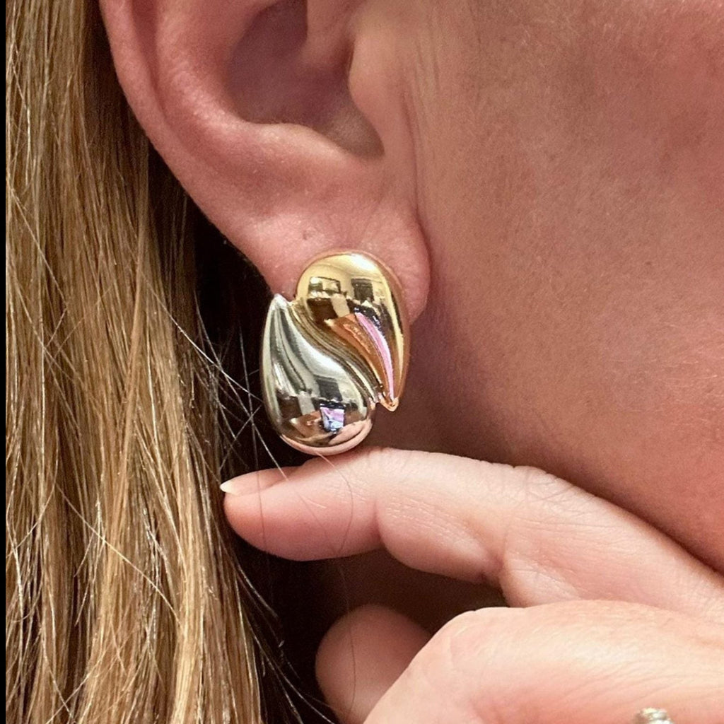 Jakris two-tone teardrop earrings featuring a polished gold and silver plated modern design worn on an earlobe