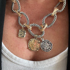 Jakris two-tone thick twisted chain necklace featuring vintage-style gold and silver coin pendants on a model