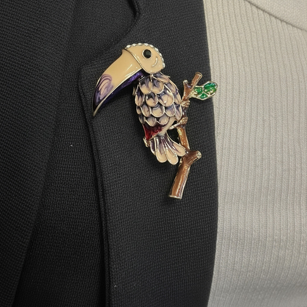 Jakris vintage enamel toucan bird brooch with colorful tropical details pinned on a black blazer lapel