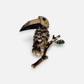 Jakris vintage enamel toucan bird brooch featuring tropical colors and a green leaf detail on a branch