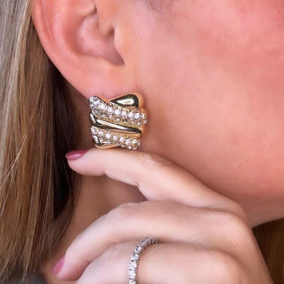 Jakris vintage style gold rectangular earrings featuring sparkling zircon stones worn on an earlobe