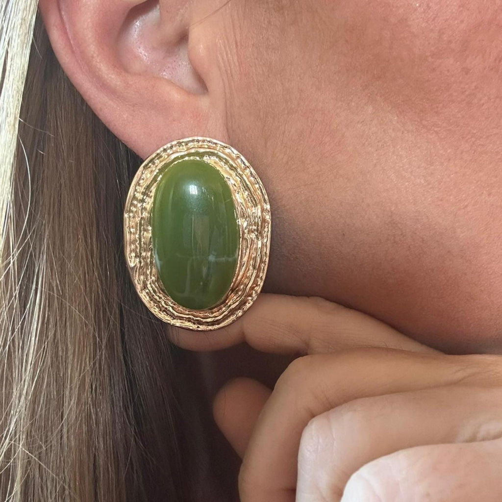 Jakris vintage-inspired gold oval earrings featuring a large smooth green stone on a textured metallic setting