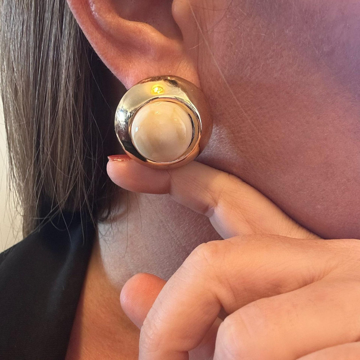 Jakris vintage round stud earring in cream and gold worn on an earlobe