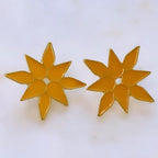 Jakris yellow enamel flower stud earrings with a star-shaped petal design on a white background.