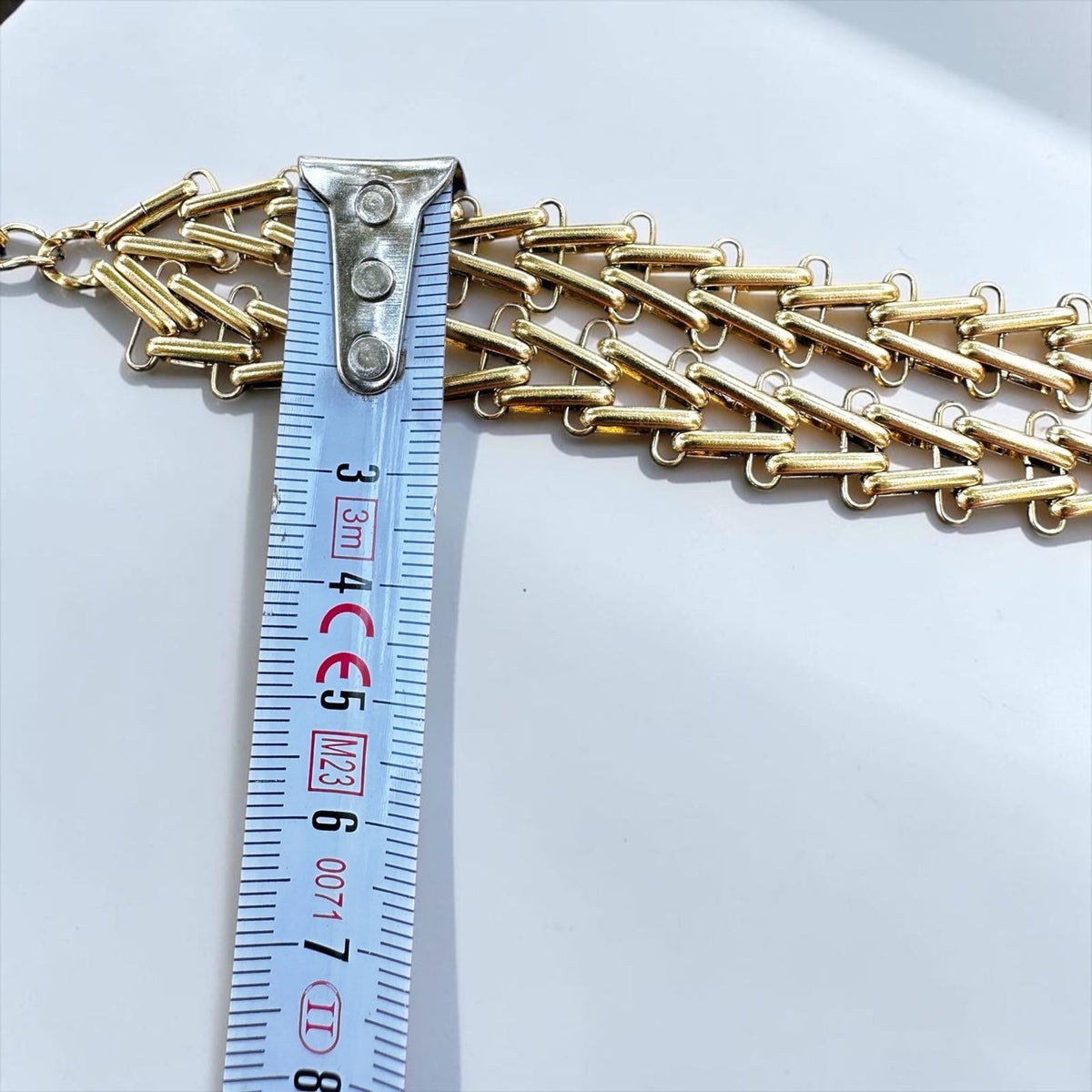 Jakris Zafira gold-tone multi-strand braided chain necklace with a measuring tape showing its width