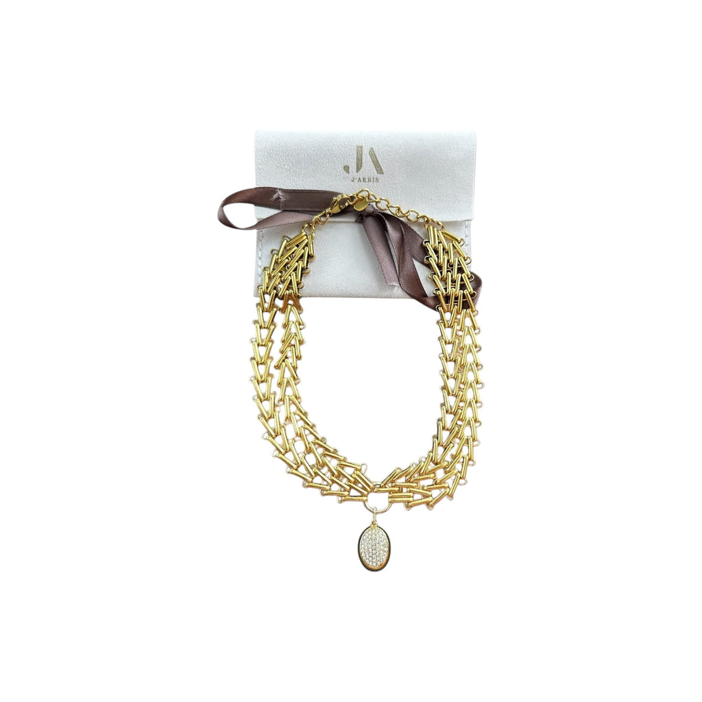 Jakris Zafira gold-tone multi-strand braided chain necklace with a central oval crystal pendant and branded pouch.
