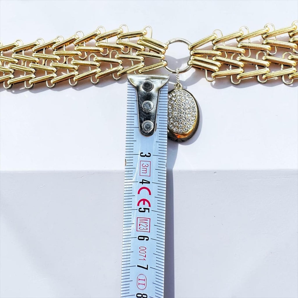 Jakris Zafira gold-tone multi-strand woven chain necklace with a crystal-embellished oval pendant and measuring tape.