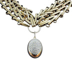 Jakris Zafira gold-tone multi-strand woven chain necklace with a central oval pendant featuring sparkling crystal stones