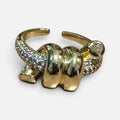 Jakris adjustable gold ring featuring a spiral knot design with sparkling zircon stone accents.